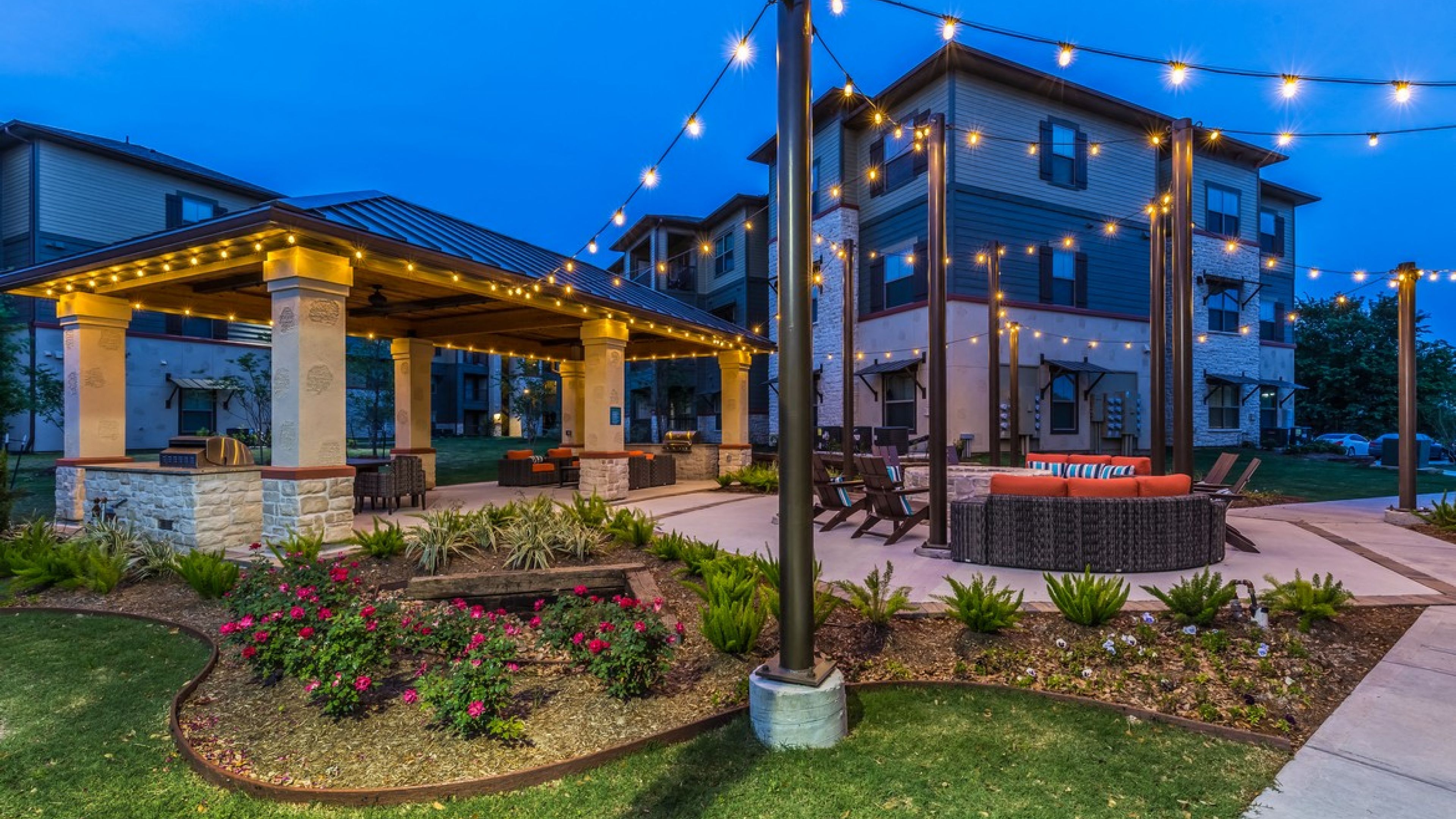 Hawthorne at Crenshaw resident clubhouse with fireplace, seating, and large screen TV