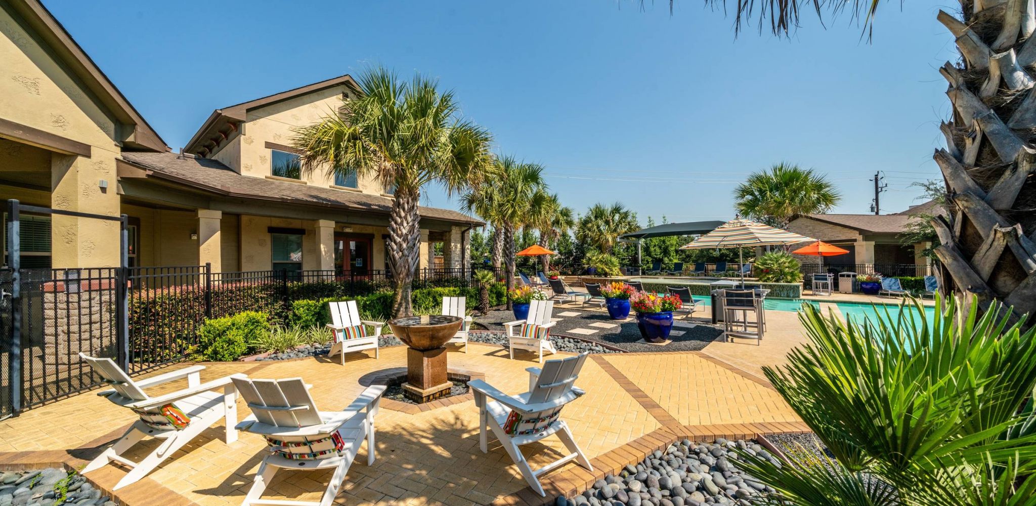 Hawthorne at Crenshaw apartments community exterior with large patio seating and outdoor pool area