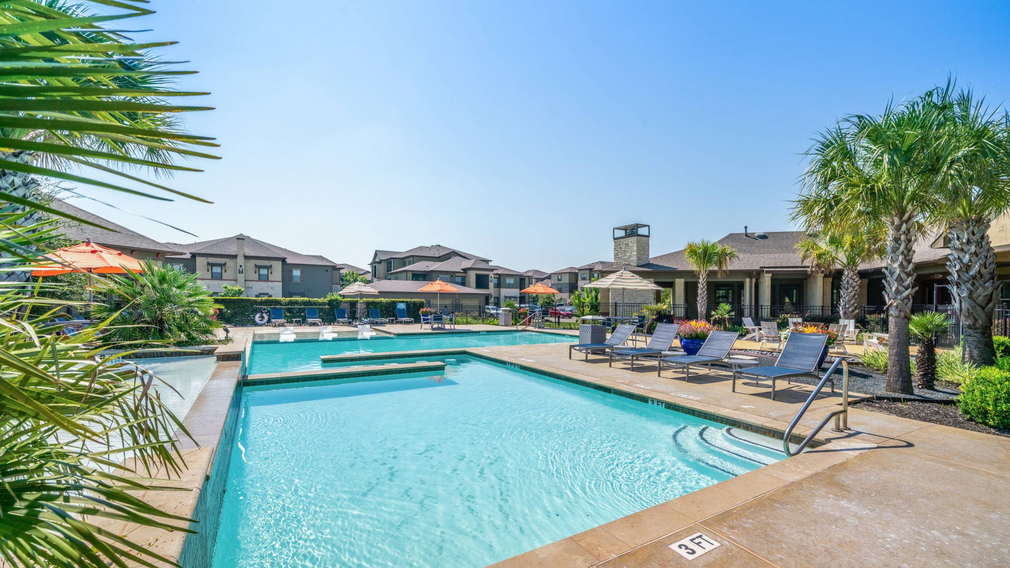 Hawthorne at Crenshaw luxury outdoor pool with in-pool lounge chairs and surrounding seating