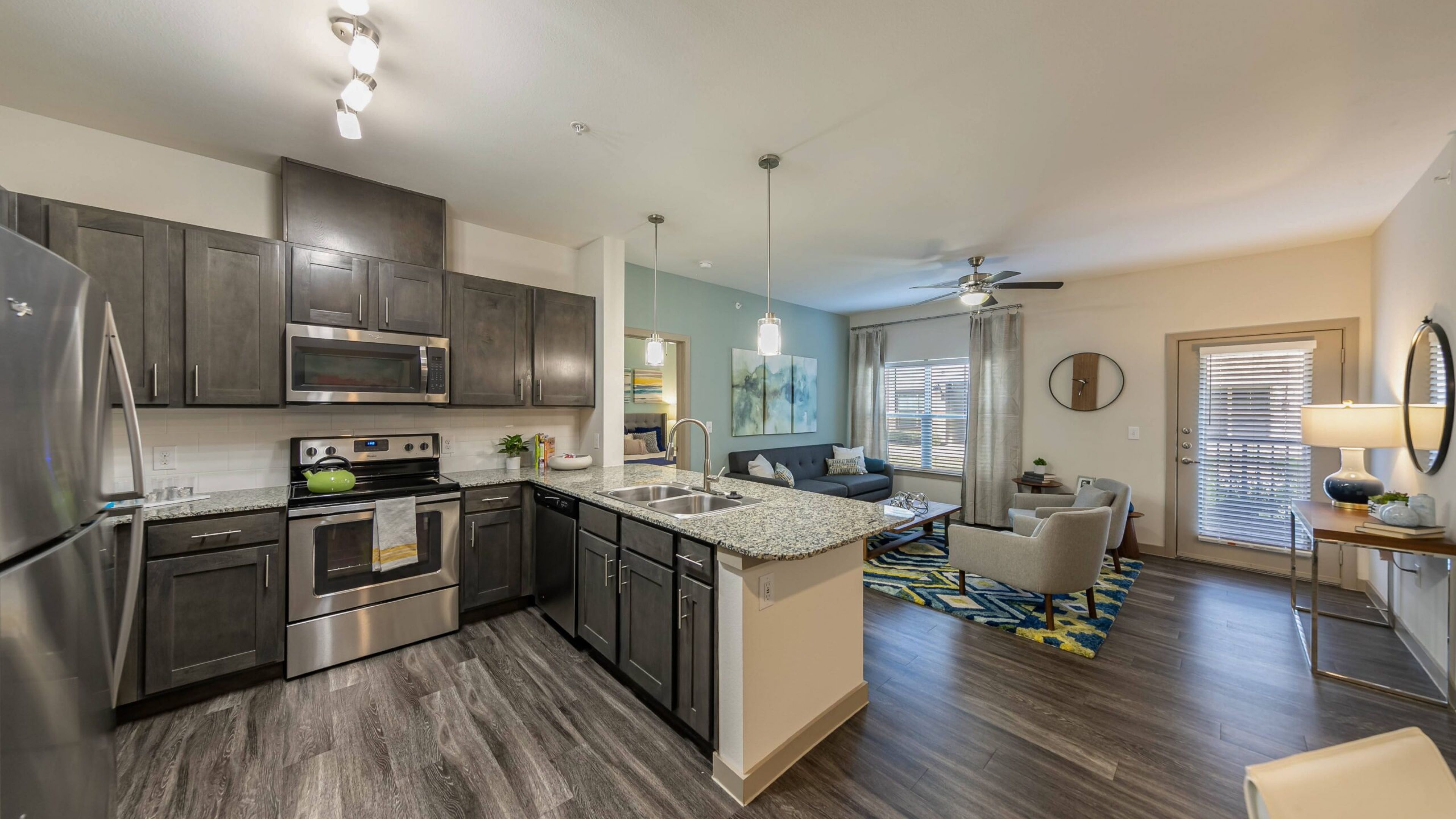 Hawthorne at Crenshaw apartment kitchen with stainless steel appliances and granite countertops